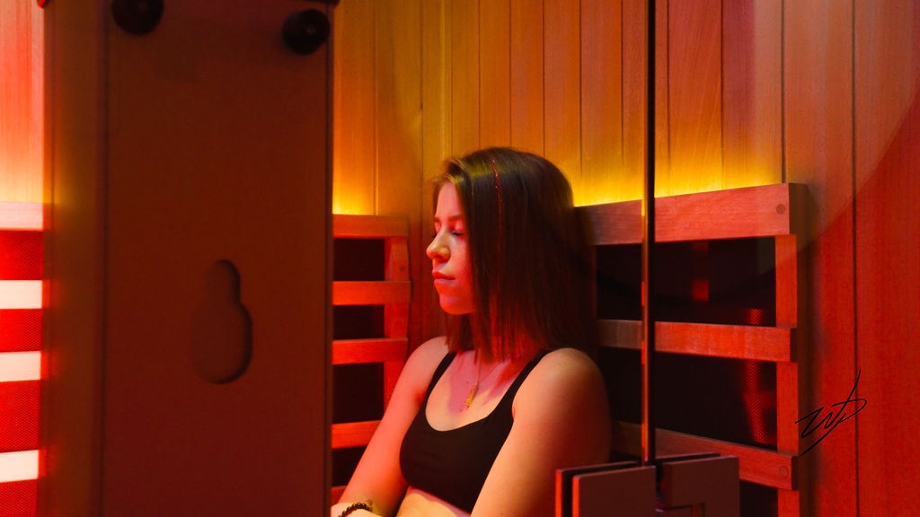 A woman sitting in an infrared sauna suite.